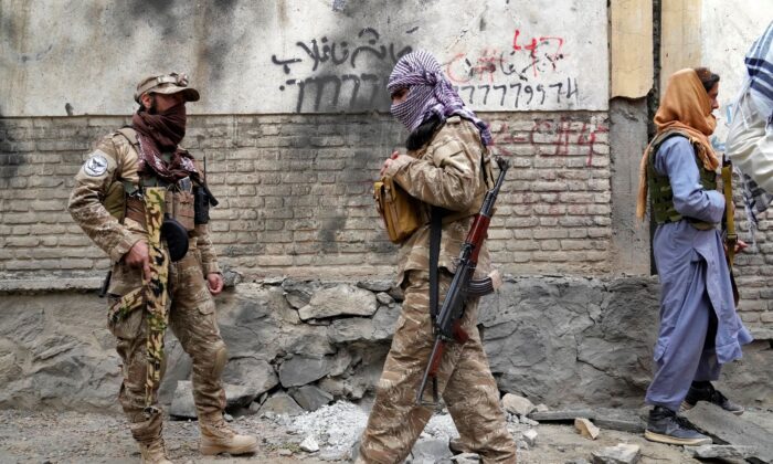 Taliban fighters stand guard at the site of an explosion in front of a school, in Kabul, Afghanistan, on April 19, 2022. (Ebrahim Noroozi/AP Photo)