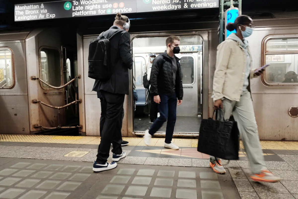 People exit a New York City subway on April 13, 2022. (Spencer Platt/Getty Images)