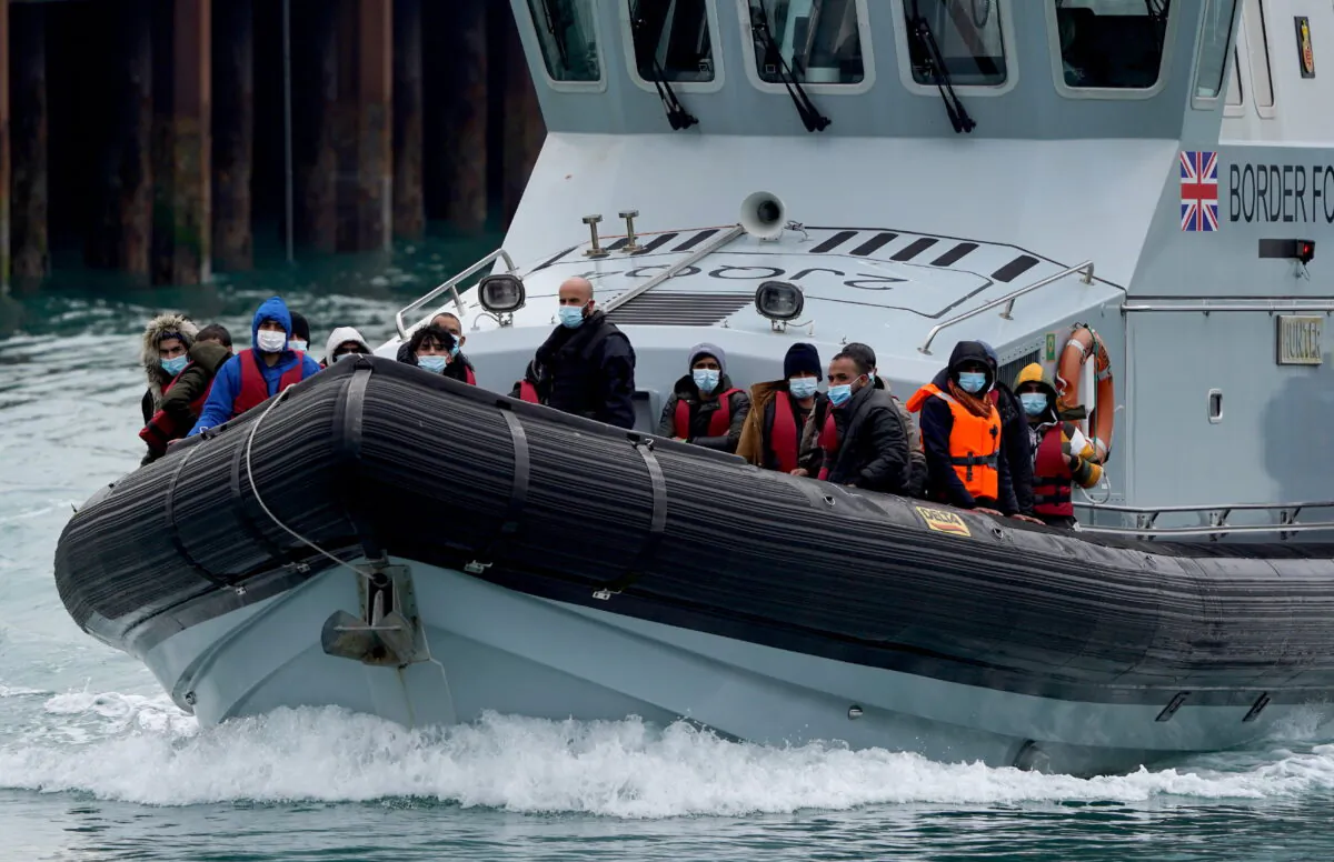 A group of people are brought into Dover, Kent, onboard a Border Force vessel following a small boat incident in the Channel on April 13, 2022. (Gareth Fuller/PA)