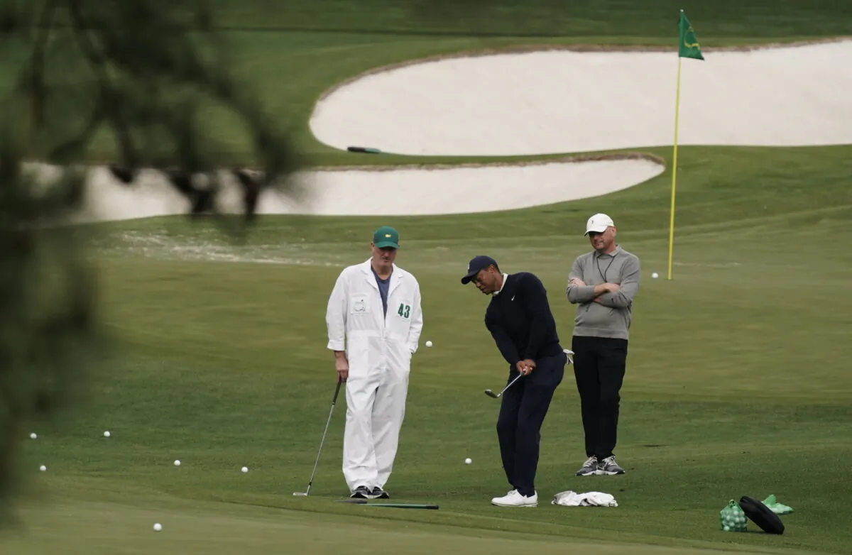 Tiger Woods hits on the driving range during a practice round for the Masters golf tournament in Augusta, Ga., on April 5, 2022. (Charlie Riedel/AP Photo)