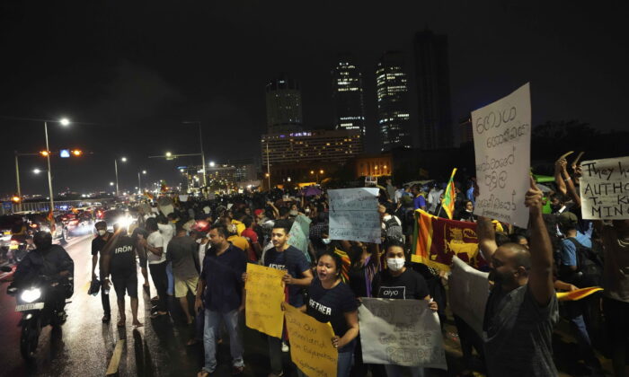 Sri Lankans during a protest outside the president's office in Colombo, Sri Lanka, on April 11, 2022. (Eranga Jayawardena/AP Photo)