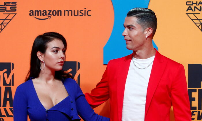 Cristiano Ronaldo and Georgina Rodriguez pose on a red carpet as they arrive at the 2019 MTV Europe Music Awards at the FIBES Conference and Exhibition Centre in Seville, Spain, on Nov. 3, 2019. (Jon Nazca/Reuters)