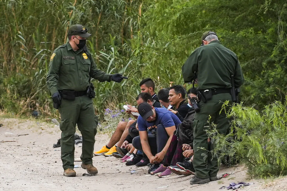 Border Patrol agents apprehend a group of Cubans who just crossed the Rio Grande from Mexico into Eagle Pass, Texas, on April 19, 2022. (Charlotte Cuthbertson/The Epoch Times)