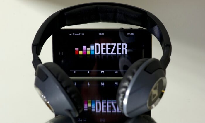 Headphone beside a smartphone connected to French music streaming website Deezer in Paris, on Oct. 9, 2012. (Lionel Bonaventure/AFP via Getty Images)