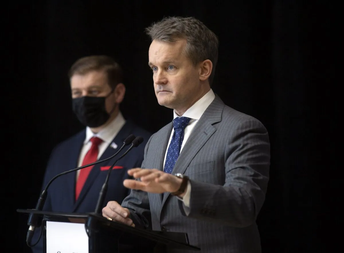 Labour Minister Seamus O'Regan takes questions as Newfoundland and Labrador Premier Andrew Furey, left, looks on during an announcement in St. John's, Feb. 14, 2022. (THE CANADIAN PRESS/Paul Daly)