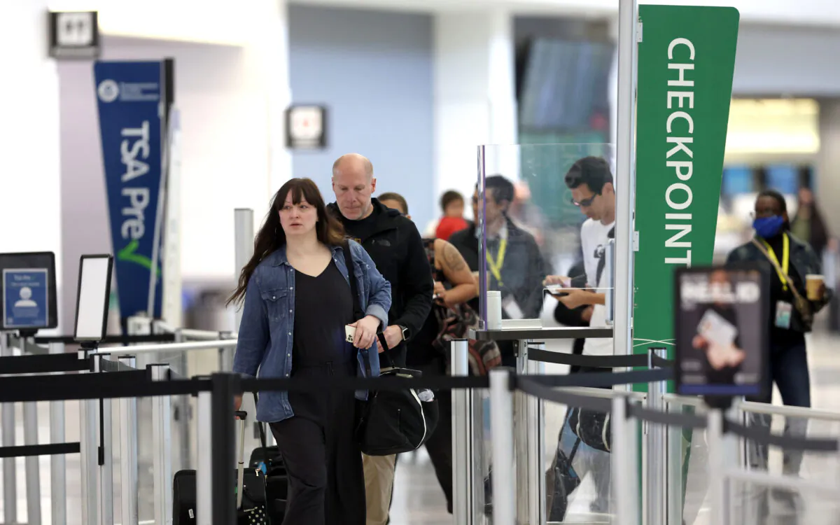 Airline passengers without masks prepare to enter a security checkpoint at San Francisco International Airport on April 19, 2022. (Justin Sullivan/Getty Images)