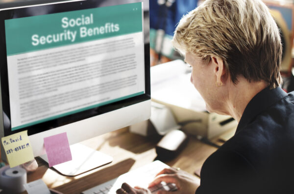 a woman looks up social security benefits on a computer