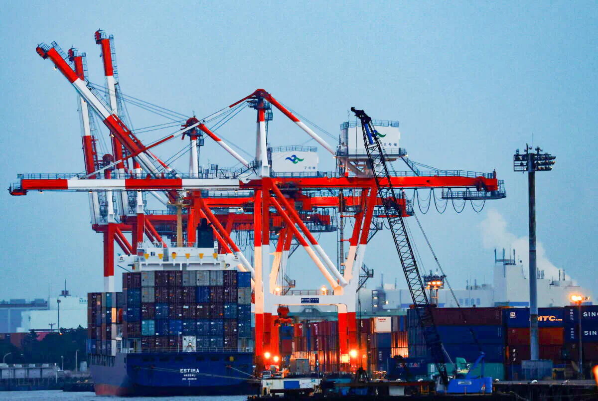 A cargo ship and containers at an industrial port in Tokyo, on Feb. 15, 2022. (Kim Kyung-Hoon/Reuters)