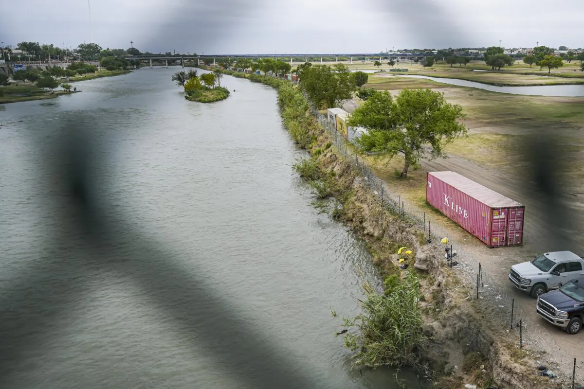 A view of the Rio Grande with Mexico on the left and the United States on the right, from the Camino Real international bridge in Eagle Pass, Texas, on April 19, 2022. (Charlotte Cuthbertson/The Epoch Times)