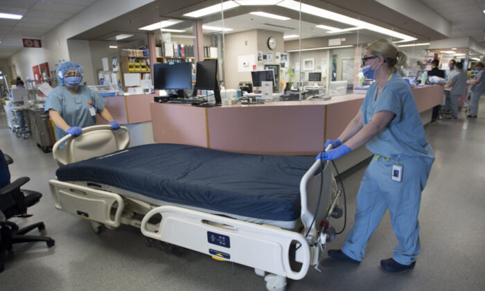 A bed is moved in the COVID-19 intensive care unit at St. Paul’s hospital in downtown Vancouver on April 21, 2020. (Jonathan Hayward/The Canadian Press)