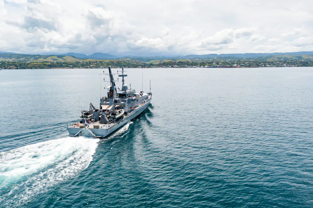 In this handout provided by the Australian Department of Defence, Armadale Class Patrol Boat, HMAS Armidale, sails into the Port of Honiara, Guadalcanal Island, Solomon Islands, on Dec. 1, 2021. (CPL Brodie Cross/Australian Department of Defence via Getty Images)