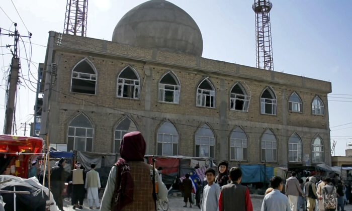 This frame grab image from video, shows a Taliban terrorist standing guard outside the site of a bomb explosion inside a mosque, in Mazar-e-Sharif Province, Afghanistan, on April 21, 2022. (AP Photo)