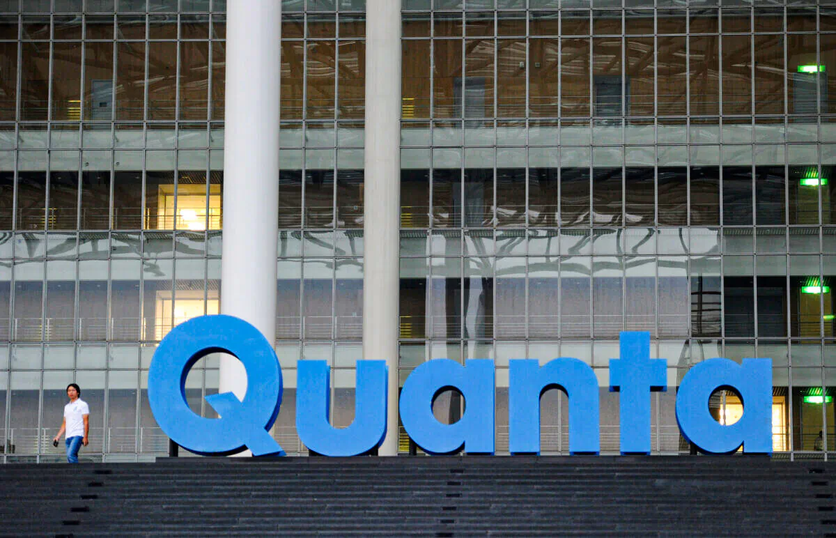 A man walks past a Quanta logo outside the company's factory in Taiwan's northern Taoyuan county on Sept. 21, 2011. (Sam Yeh/AFP via Getty Images)