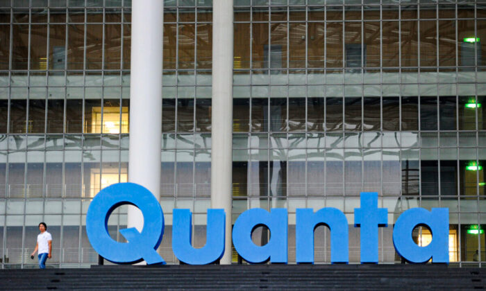A man walks past a Quanta logo outside the company's factory in Taiwan's northern Taoyuan county on Sept. 21, 2011. (Sam Yeh/AFP via Getty Images)