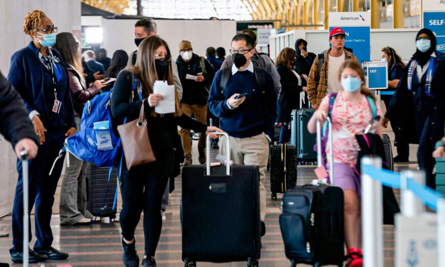 Travelers walk through Ronald Reagan Washington National Airport in Arlington, Va., on April 19, 2022. (Stefani Reynolds/AFP via Getty Images)