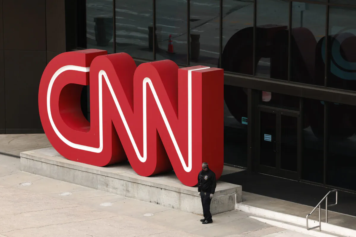 A libel suit against CNN typifies what average people are up against if they are damaged by a story. Here, people walk by the world headquarters for the Cable News Network (CNN) in Atlanta on March 15, 2022. (Anna Moneymaker/Getty Images)