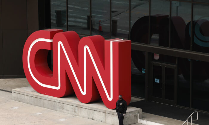 A libel suit against CNN typifies what average people are up against if they are damaged by a story. Here, people walk by the world headquarters for the Cable News Network (CNN) in Atlanta on March 15, 2022. (Anna Moneymaker/Getty Images)