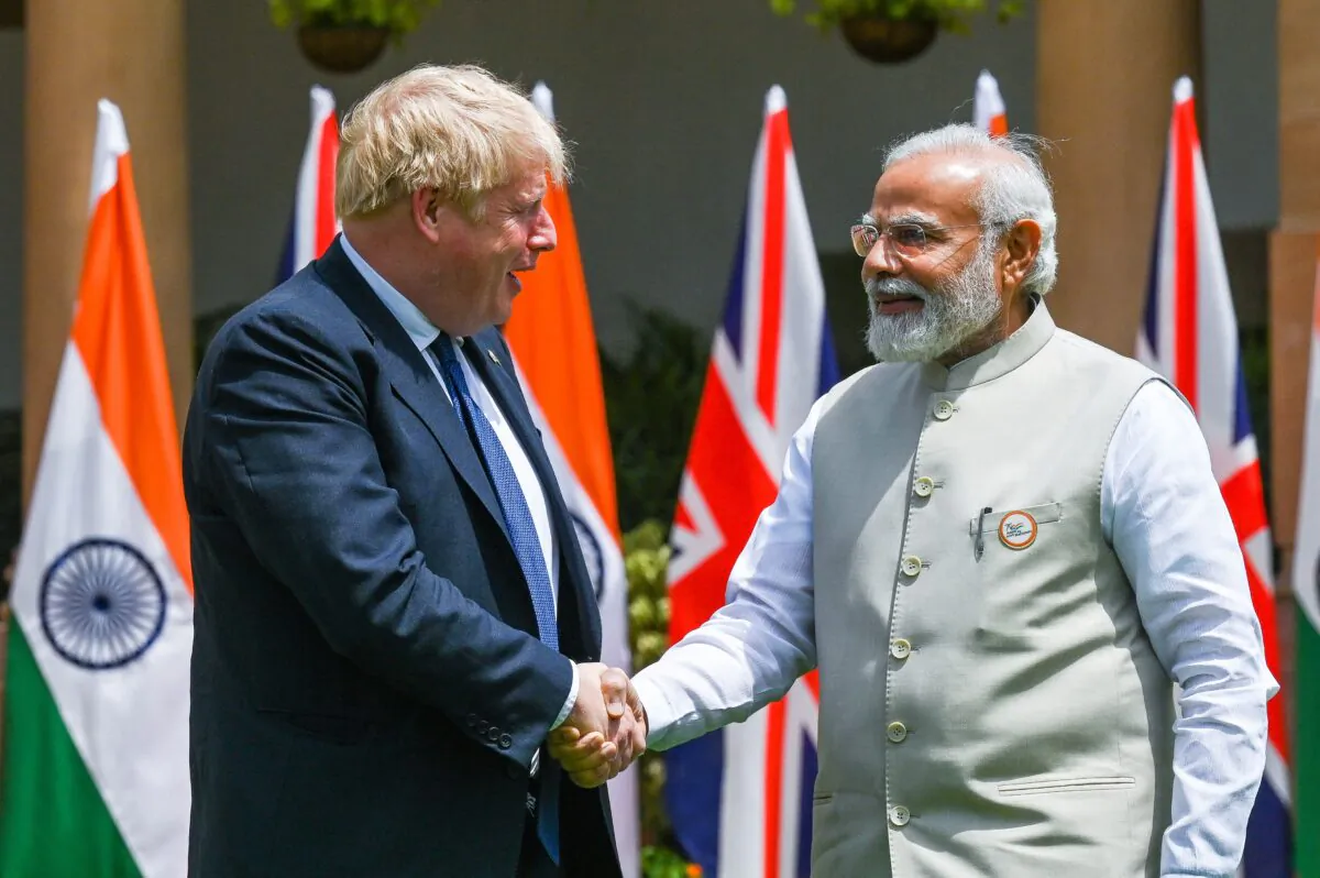 India's Prime Minister Narendra Modi (R) shakes hands with his British Prime Minister Boris Johnson before a meeting in New Delhi on April 22, 2022. (Prakash Singh /AFP via Getty Images)