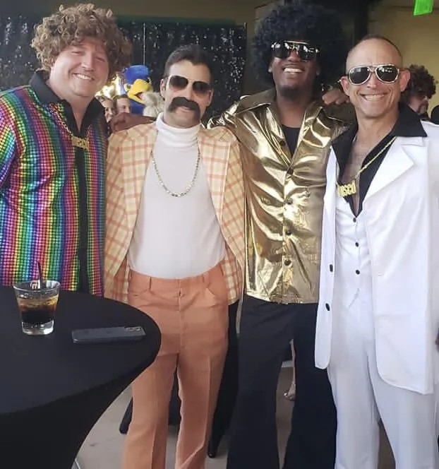 DJ Kim Koko Hunter (2R) appears in disco period clothing at a charity dance in Scottsdale, Arizona, on April 9. Hunter was accused of appearing in blackface. (Courtesy of Kim Koko Hunter)
