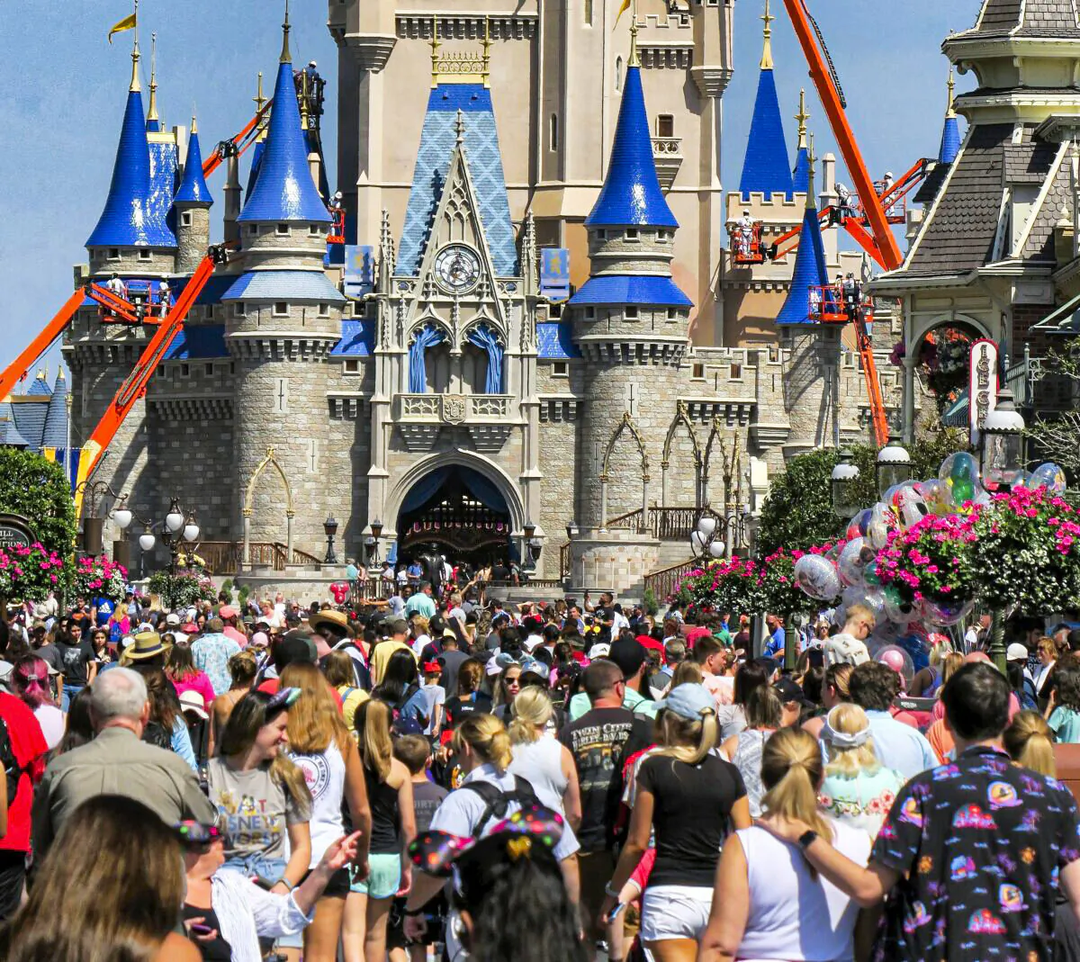 In this March 12, 2020, file photo, a crowd is shown along Main Street USA in front of Cinderella Castle in the Magic Kingdom at Walt Disney World in Lake Buena Vista, Fla. (Joe Burbank/Orlando Sentinel via AP)