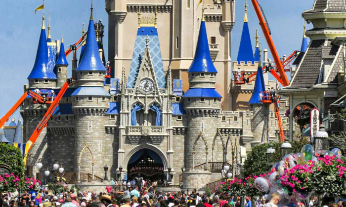 A crowd along Main Street USA in front of Cinderella Castle in the Magic Kingdom at Walt Disney World in Lake Buena Vista, Fla., on March 12, 2020. (Joe Burbank/Orlando Sentinel via AP)