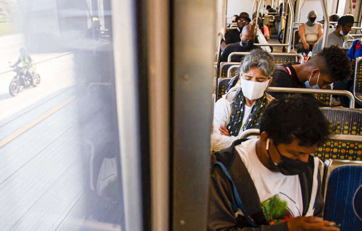 Transit passengers wear masks as they ride a light rail train in Los Angeles, California, on July 16, 2021. (Patrick T. Fallon/AFP via Getty Images)