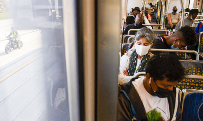 Transit passengers wear masks as they ride a light rail train in Los Angeles, California, on July 16, 2021. (Patrick T. Fallon/AFP via Getty Images)