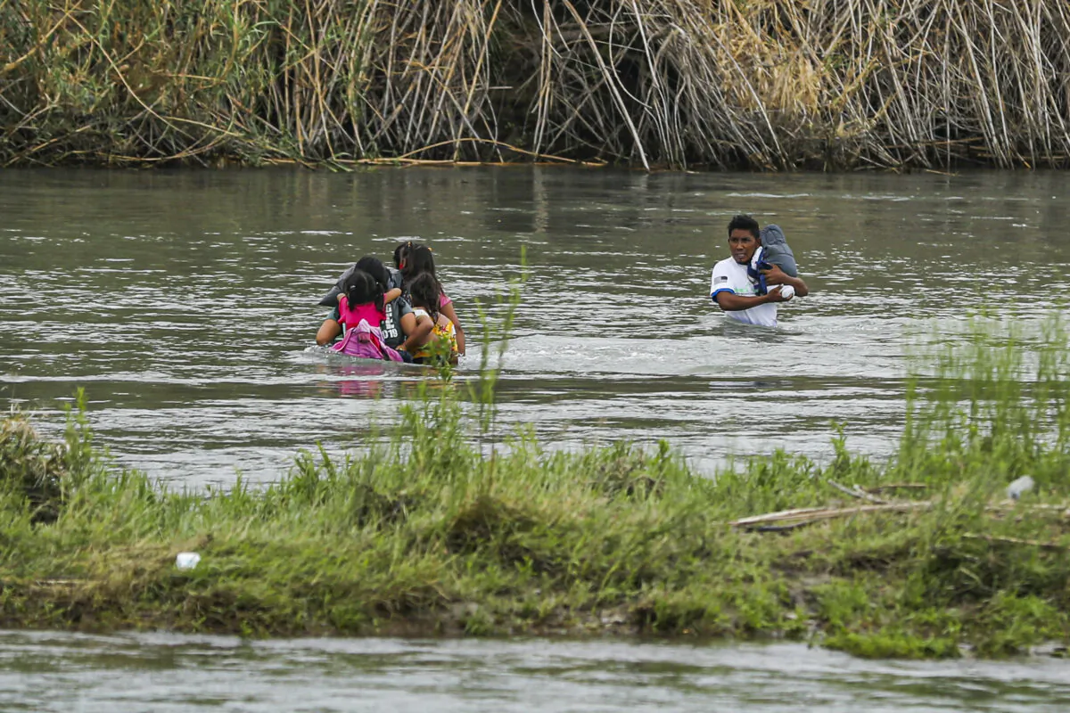 A group of Hondurans cross the Rio Grande toward Eagle Pass, Texas in a file photo. (Charlotte Cuthbertson/The Epoch Times)