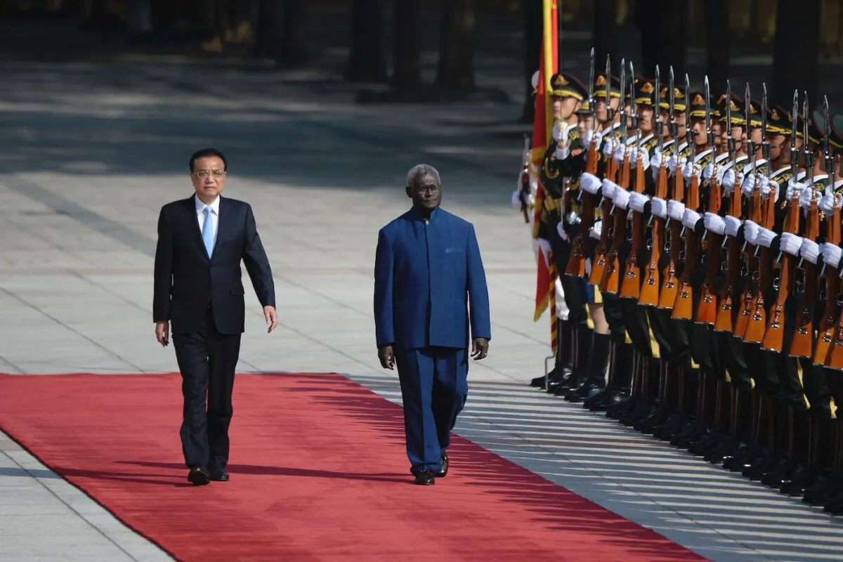 Solomon Islands Prime Minister Manasseh Sogavare and Chinese Premier Li Keqiang inspect honour guards at the Great Hall of the People in Beijing on Oct. 9, 2019. (Wang Zhao/AFP via Getty Images)