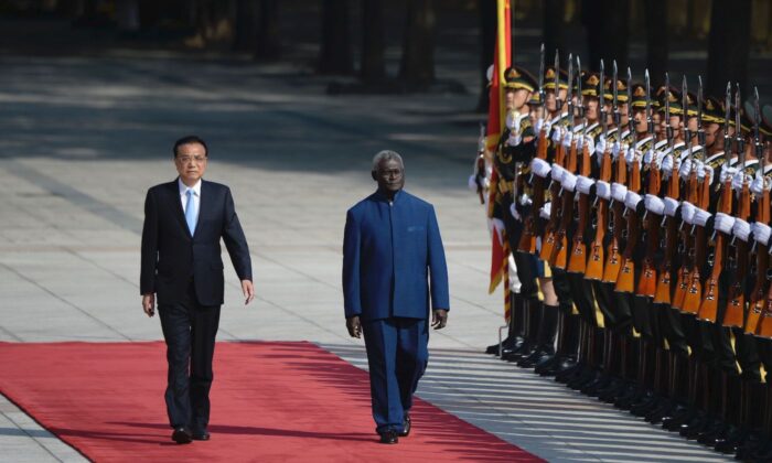 Solomon Islands Prime Minister Manasseh Sogavare and Chinese Premier Li Keqiang inspect honor guards at the Great Hall of the People in Beijing, China, on Oct. 9, 2019. (Wang Zhao/AFP via Getty Images)