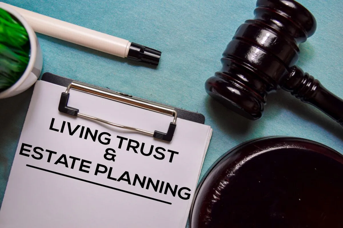 Living trust and Estate Planning text on Document form and Gavel isolated on office desk. (Bangoland/ShutterStock)