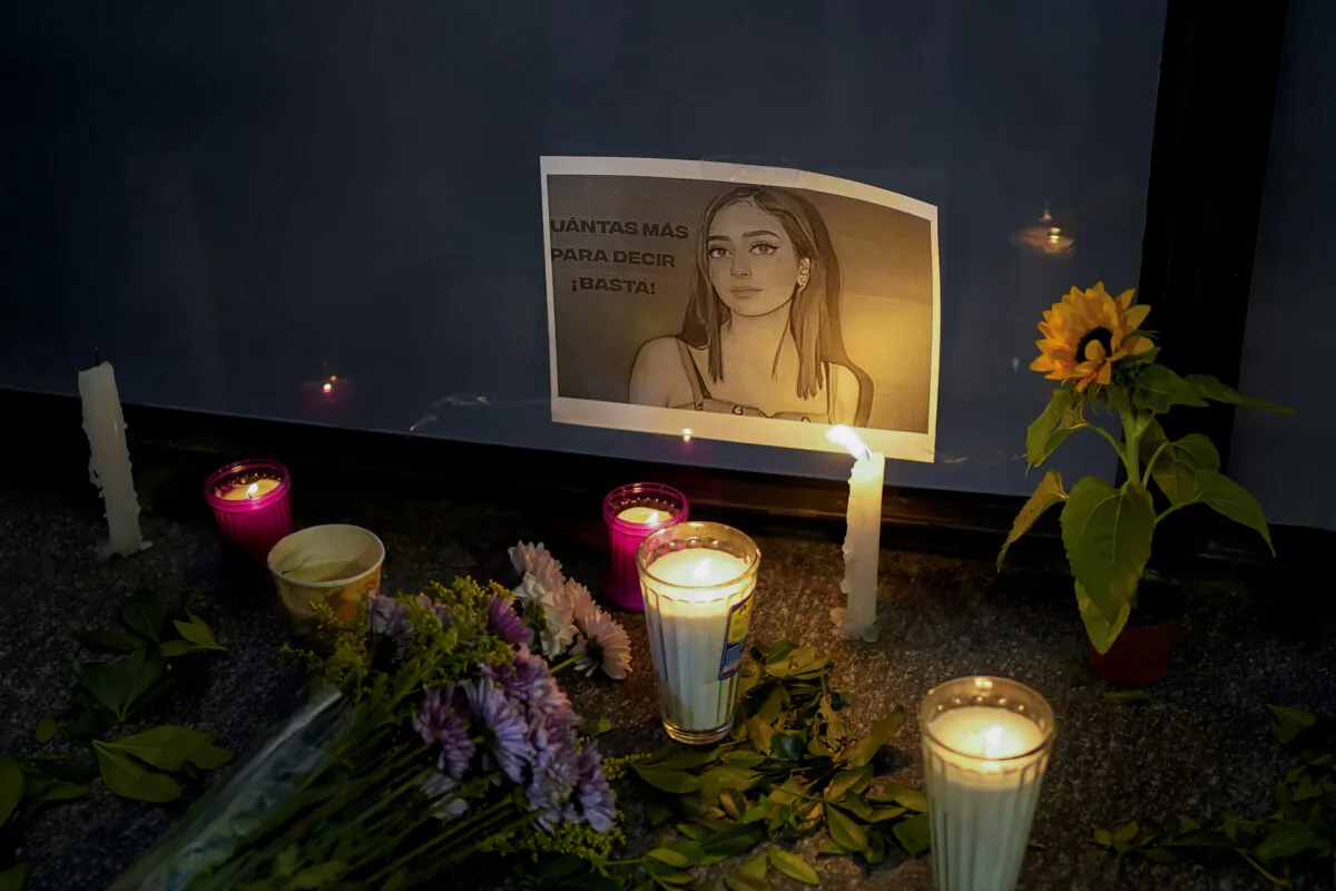 Candles and flowers surround an image of Debanhi Escobar during a protest against the disappearance of Escobar and other women, at the Attorney General's office in Mexico City, on April 22, 2022. (Eduardo Verdugo/AP Photo)