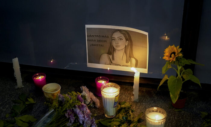 Candles and flowers surround an image of Debanhi Escobar during a protest against the disappearance of Escobar and other women, at the Attorney General's office in Mexico City, on April 22, 2022. (Eduardo Verdugo/AP Photo)