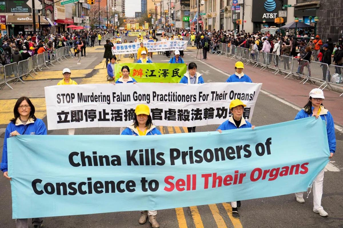 Falun Gong practitioners take part in a parade to raise awareness about the Chinese regime's brutal persecution of the spritual practice, including forced organ harvesting, in New York on May 13, 2022.
Larry Dye/The Epoch Times