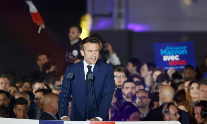 French President and La Republique en Marche (LREM) party candidate for reelection Emmanuel Macron celebrates after his victory in France's presidential election, at the Champ de Mars in Paris, on April 24, 2022. (Ludovic Marin/AFP via Getty Images)