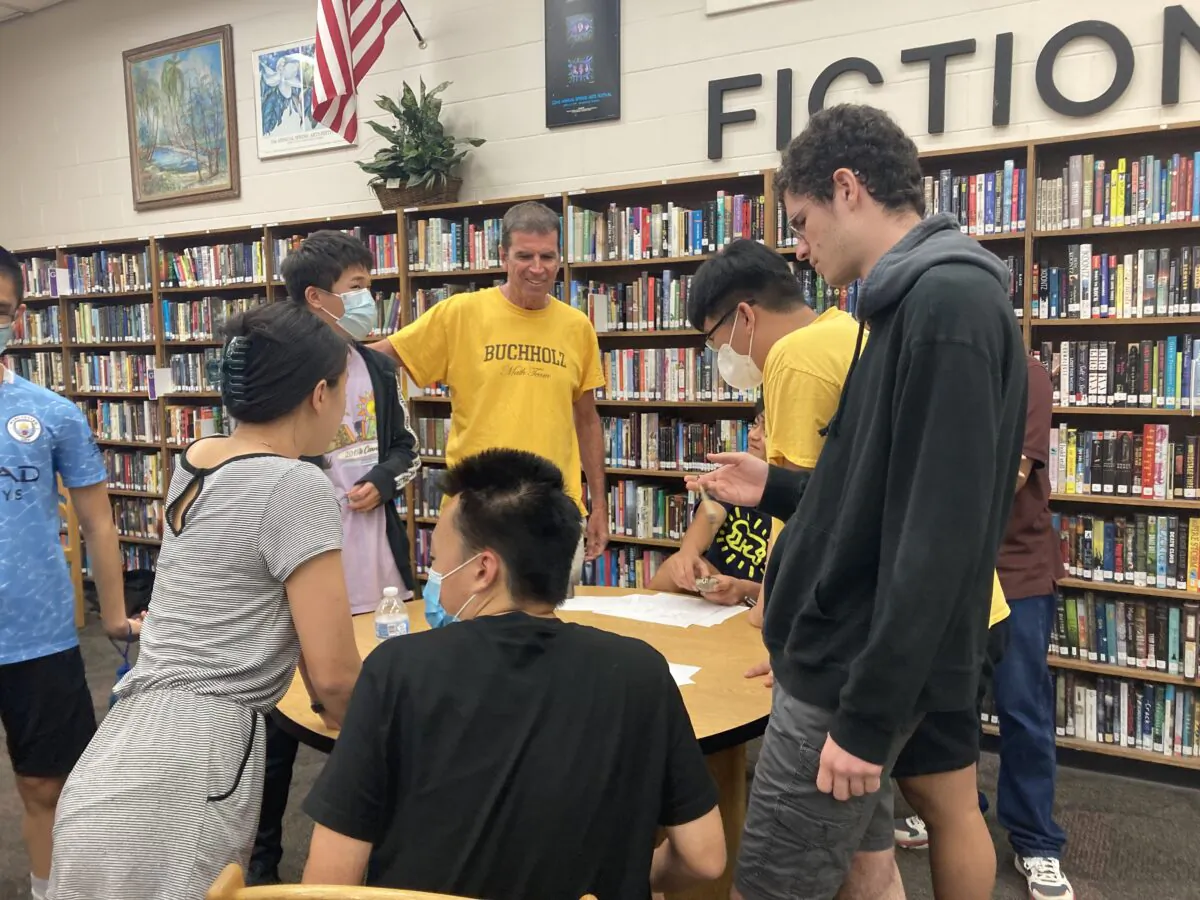 Teacher Will Frazer chats with Buchholz High School students between rounds at an American Regions Mathematics League competition at their school in Gainesville, Fla. on April 23, 2022. (Courtesy of Himal Bamzai-Wokhlu)