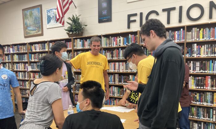 Teacher Will Frazer chats with Buchholz High School students between rounds at an American Regions Mathematics League competition at their school in Gainesville, Fla. on April 23, 2022. (Photo courtesy of Himal Bamzai-Wokhlu)