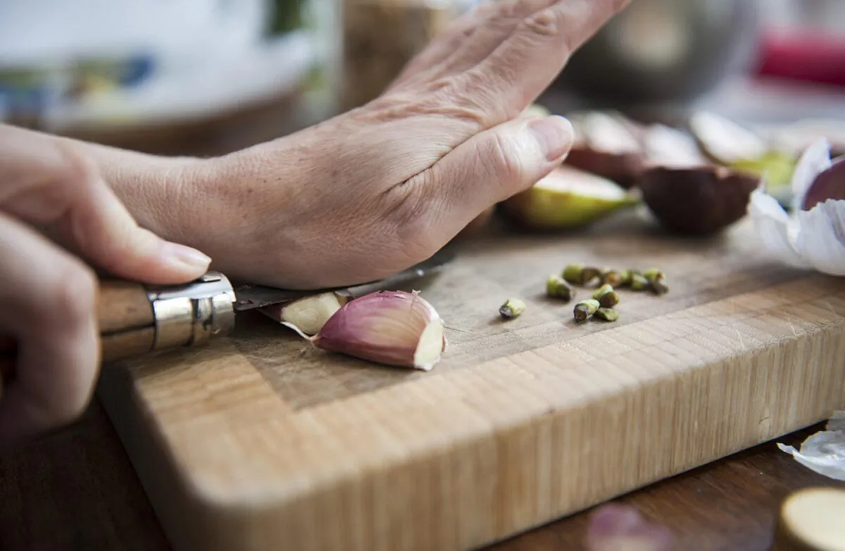 To peel your garlic, you’re going to want to crush the cloves against your countertop.  (Photo courtesy of Lucy Lambriex/DigitalVision via Getty Images)