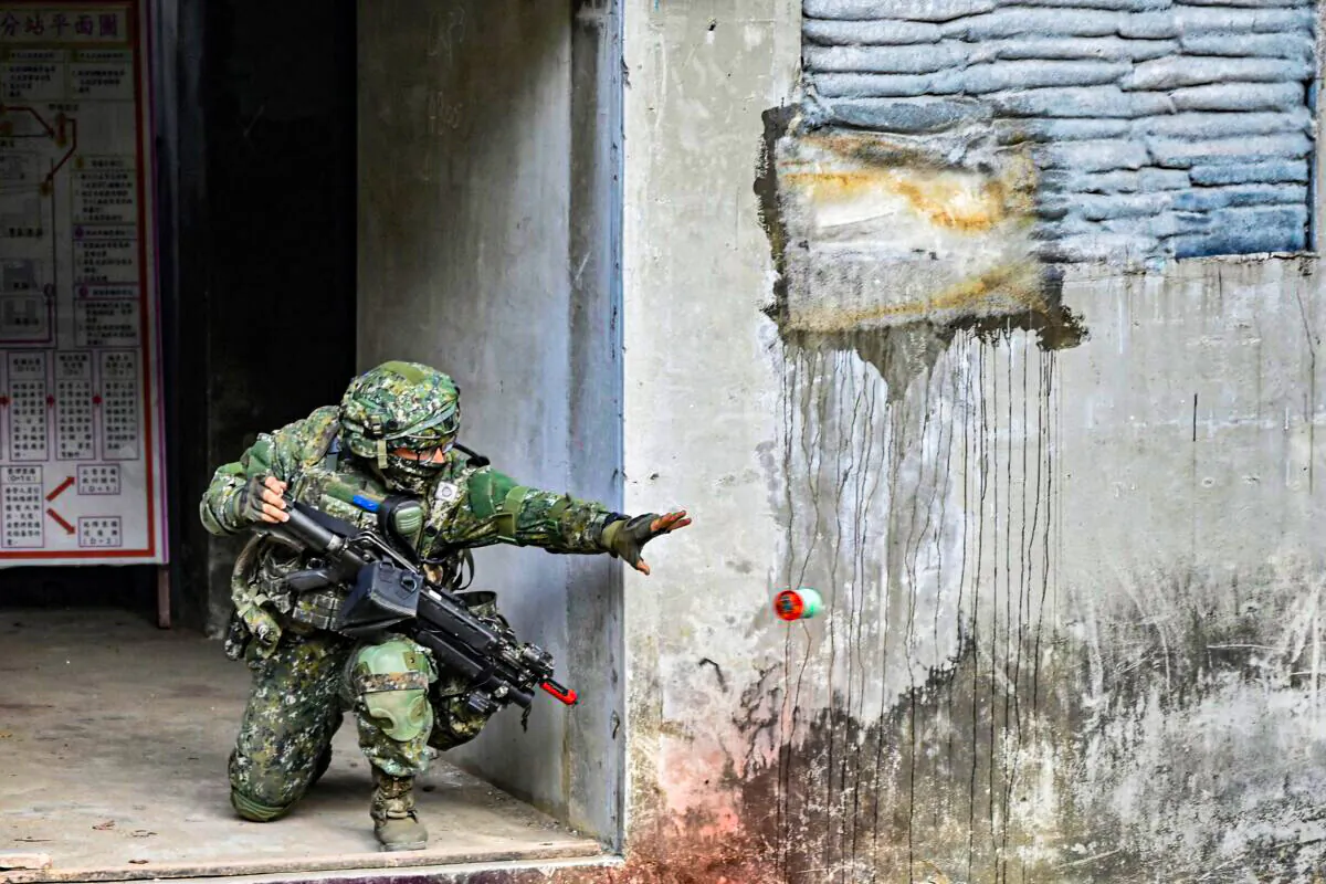 A Taiwanese soldier throws a smoke bomb during a demonstration at an army base in Kaohsiung on Jan. 6, 2022. (Sam Yeh/AFP via Getty Images)
