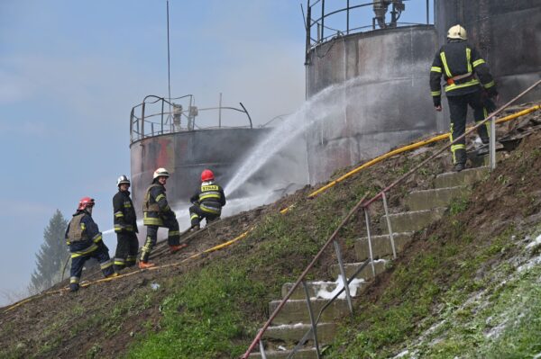 Firefighters are at work to put out a fire at an oil depot