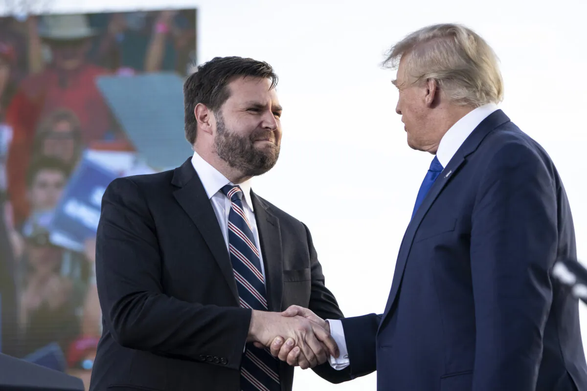 J.D. Vance (L), a Republican candidate for U.S. Senate in Ohio, shakes hands with former president Donald Trump during a rally at the Delaware County Fairgrounds in Ohio on April 23, 2022. (Drew Angerer/Getty Images)