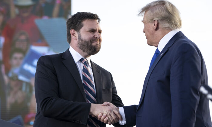 J.D. Vance (L), a Republican candidate for U.S. Senate in Ohio, shakes hands with former president Donald Trump during a rally at the Delaware County Fairgrounds in Ohio on April 23, 2022. (Drew Angerer/Getty Images)