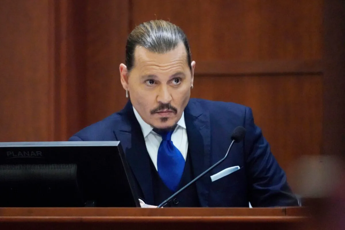 Actor Johnny Depp sits to testify in the courtroom at the Fairfax County Circuit Courthouse in Fairfax, Va., on April 25, 2022. (Steve Helber/Pool/AFP via Getty Images)