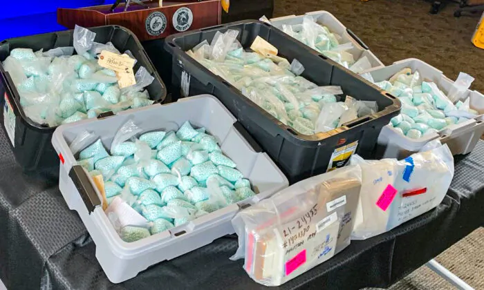 Illicit fentanyl-laced pills and other narcotics are displayed by law enforcement during a press conference in Scottsdale, Ariz., on Dec. 16, 2021. (Scottsdale PD)