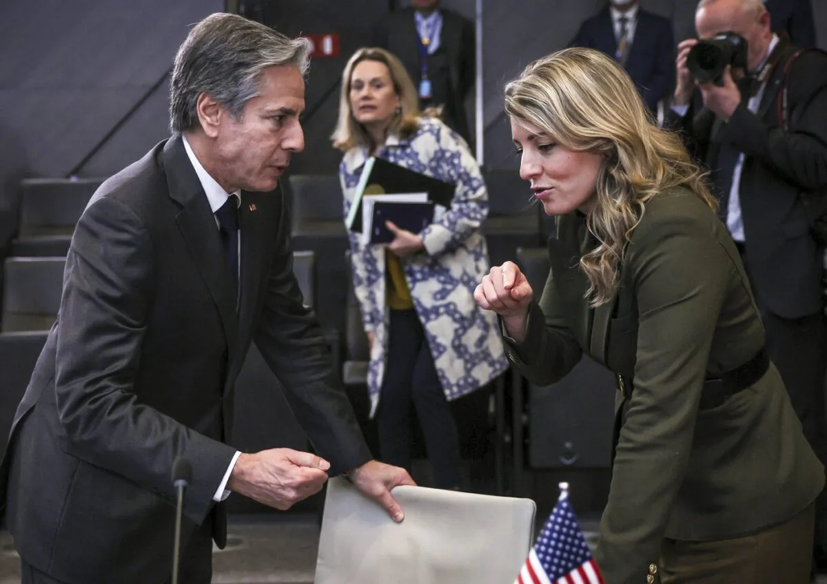 U.S. Secretary of State Antony Blinken and Canadian Foreign Minister Melaine Joly talk after a meeting with NATO foreign ministers at NATO headquarters in Brussels, Belgium, April 7, 2022. (The Canadian Press/AP-Evelyn Hockstein/Pool Photo via AP)
