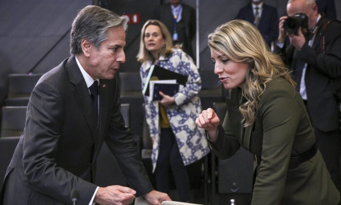 U.S. Secretary of State Antony Blinken and Canadian Foreign Minister Melaine Joly talk after a meeting with NATO foreign ministers at NATO headquarters in Brussels, Belgium, April 7, 2022. (The Canadian Press/AP-Evelyn Hockstein/Pool Photo via AP)