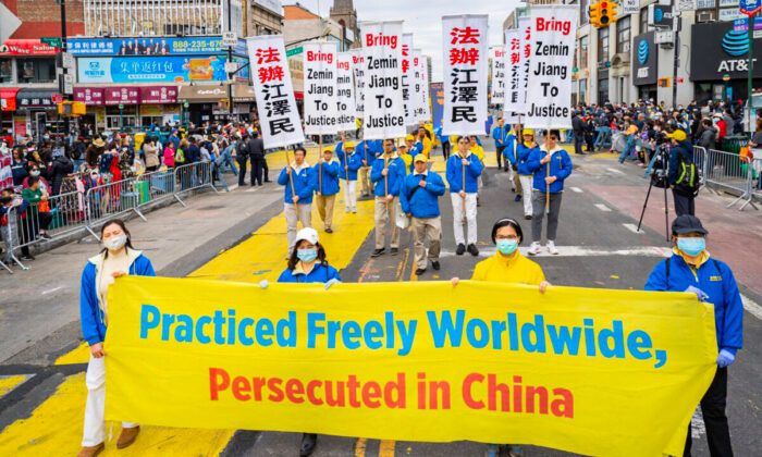 Falun Gong practitioners participate in a parade to commemorate the 23rd anniversary of the April 25th peaceful appeal of 10,000 Falun Gong practitioners in Beijing, in Flushing, N.Y., on April 23, 2022. (Larry Dye/The Epoch Times)