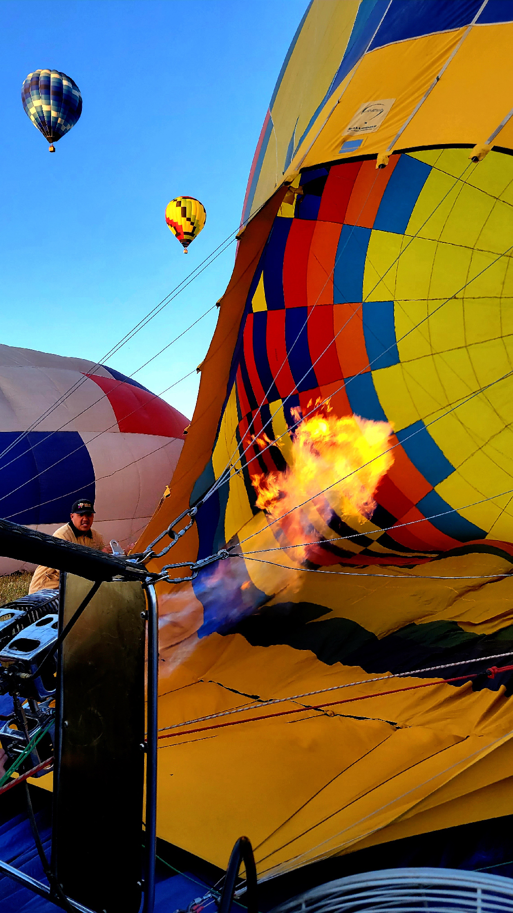 A balloonist in Temecula, California, fires up the burner that will cause his balloon to inflate.