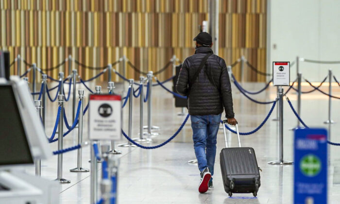 A passenger checks into their flight in the departures area in Terminal 5 at Heathrow Airport in west London on May 13, 2021. (Steve Parsons/PA)