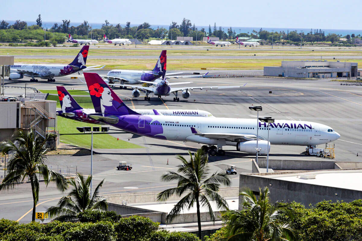 Hawaiian Airlines airplanes sit idle on the runway at the Daniel K. Inouye International Airport in Honolulu, Hawaii, on April 28, 2020. (Marco Garcia/Reuters)